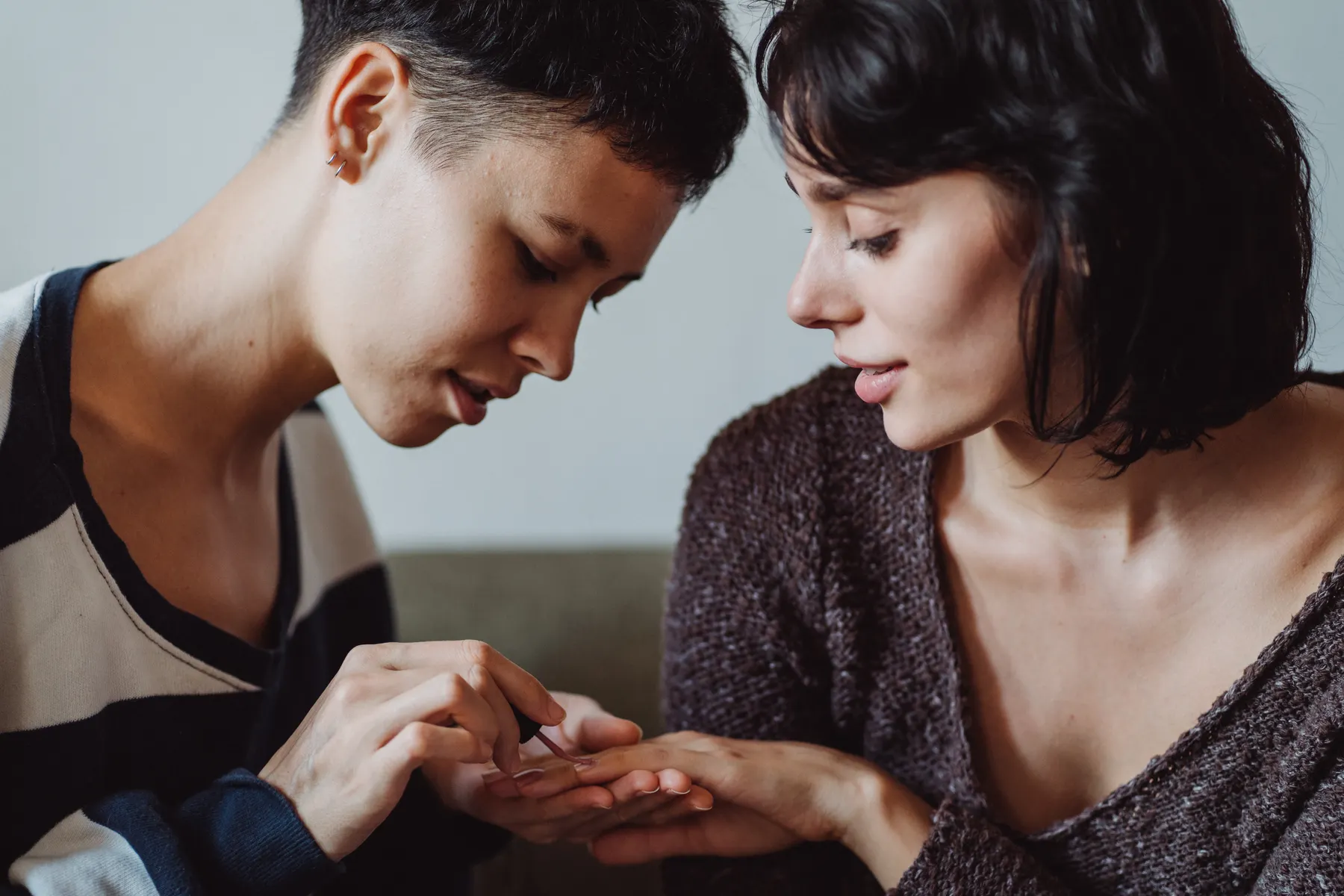 Two friends enjoying a relaxed nail painting session at home